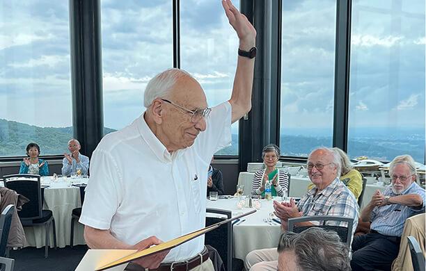 Marvin White waves at a dinner in Wood Dining Room