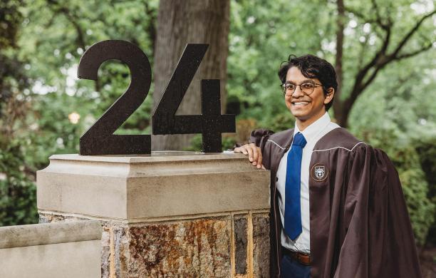 Yash Patel smiling in his graduation regalia next to the Lehigh numbers.