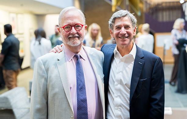 Jon Ballis '91 puts his arm around Prof. Richard Matthews