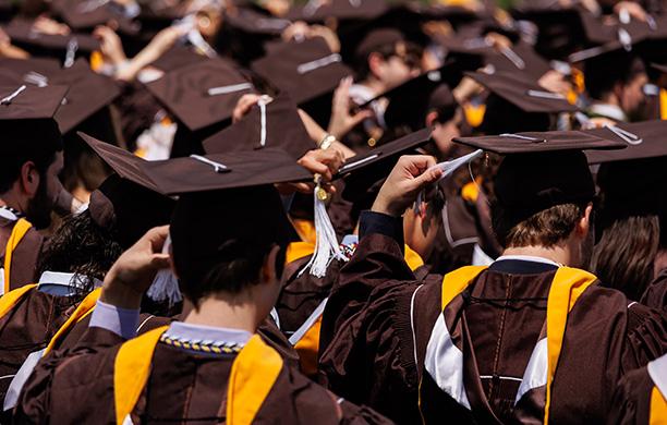 Lehigh students in their caps and gowns move their tassels