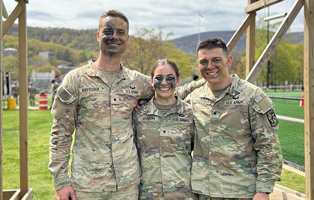 Ethan Amershek ’25, Sacha Joseph ’25, and Angelo Daddona ’25 have camo paint on their faces 