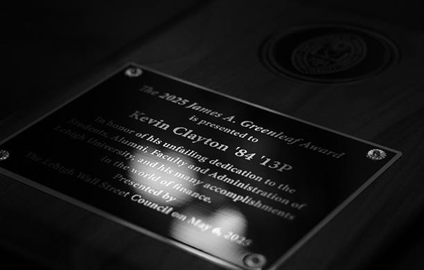 Dramatic black and white image of Wall St award with inscription
