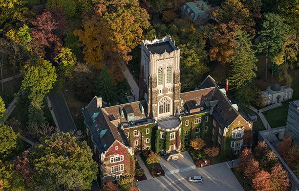 Alumni Memorial as photographed from above, surrounded by shades of green and orange foliage.