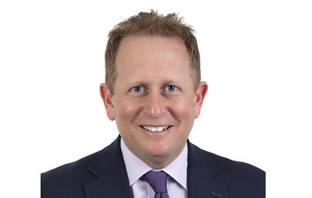 Josh Fiske in a purple tie and blue sport coat