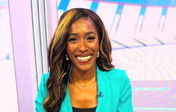 Renee smiles and wears a bright aqua blazer and black undershirt while on television. 