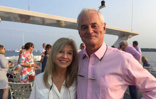 Pat Jackson and David Jackson '67 stand together on a boat.