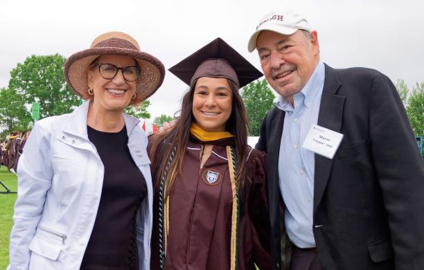 Dakota Feldman ’24, wearing a cap and gown, stands with Harriet and Myron Trepper at Lehigh University’s Commencement.