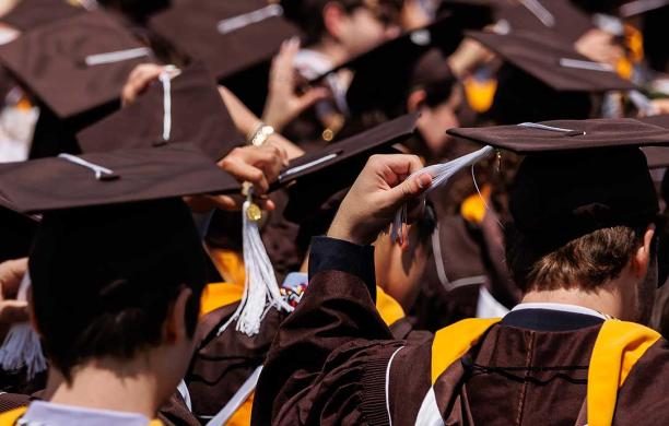 Lehigh students in their caps and gowns move their tassels