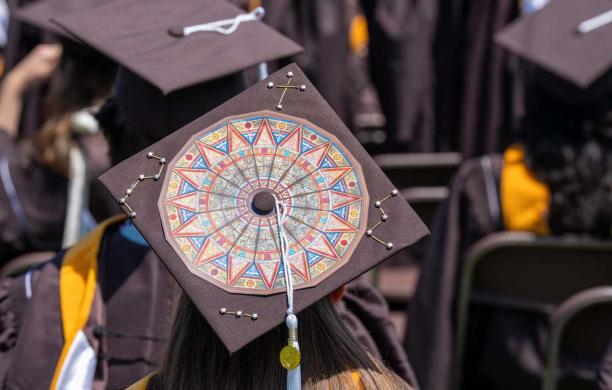 A brown graduation cap with a large image showing the Linderman Rotunda.
