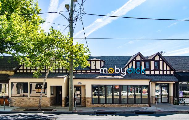 The outside of Moby Dick's location in Bethesda. The Moby Dick logo on the building features a whale tale inside the yellow 'o'.