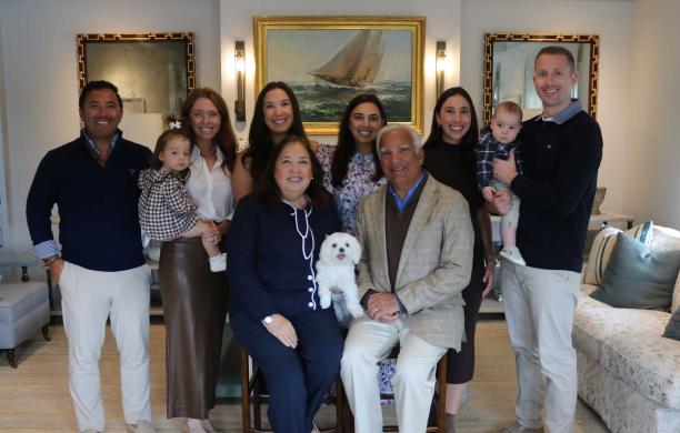 The Maida family gather in their living room for a posed photo. 