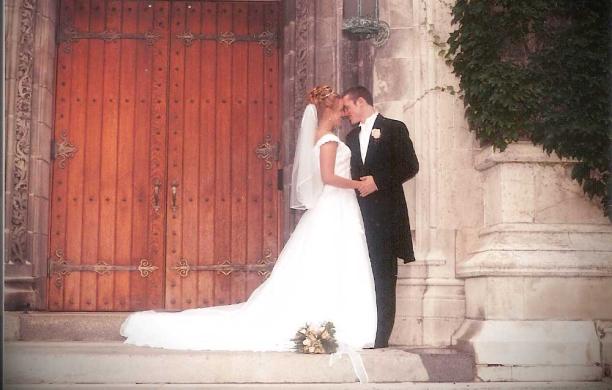Kelly and Kevin outside of Packer Memorial Church on their wedding day. Kelly wears a dress and veil; Kevin wears a black suit.