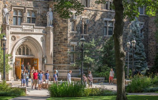 The exterior of Packard Lab on a bright fall day, showing students in tshirts exiting the front of the building after the first day of classes.