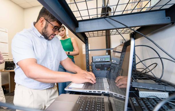 Students working on a laptop.