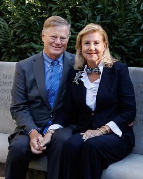 Geoffrey P. Pohanka and Anne R. Kline sitting on a stone bend in Leadership Plaza.