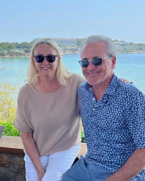 Deborah and Clifford White sitting before a bright blue ocean