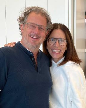 Greg Welch and Ann Lewnes standing in a kitchen, smiling