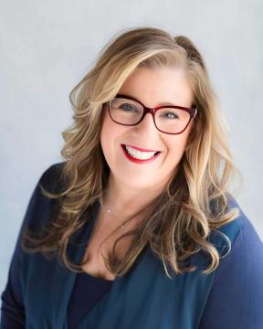 Stacy Lettie wearing a blue suit jacket.