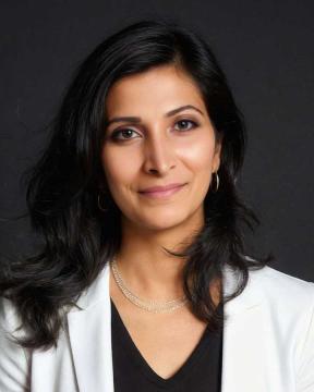Lakshmi Reddy wearing a white suit jacket