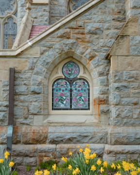 A window embedded in the side of a stone staircase