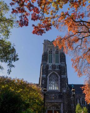 Alumni Memorial surrounded by orange and green leaves.