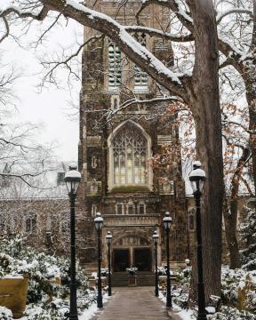 Alumni Memorial stands tall in the snowy expanse of campus.