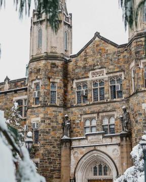 Packard Lab framed by snowy pine branches.