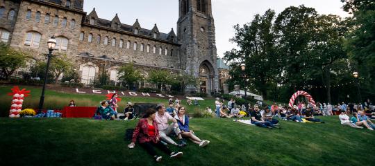 Families gather on the lawn for the Brown and White BBQ