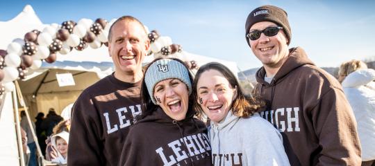 A family posing for a group shot with brown and white Lehigh sweatshirts