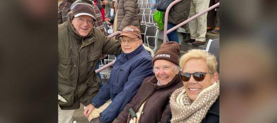 Joe Workman ’53 sitting with his family in the stands at Goodman Stadium
