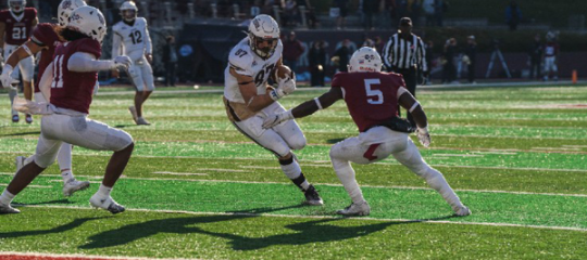 Lehigh football players with the ball during the 158th Rivalry game