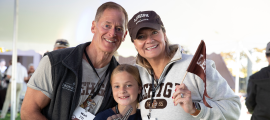 Smiling family wearing brown and white Lehigh gear