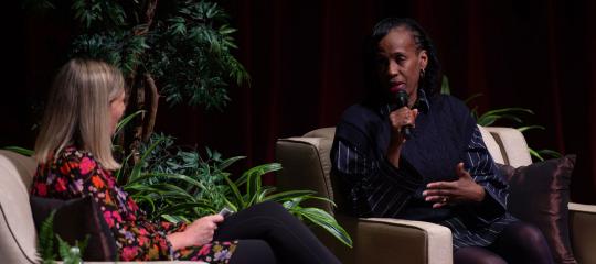Sue Troyan and Jackie Joyner-Kersee chatting in comfortable chairs
