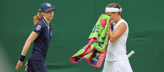 Eliza Wastcoat waits to take a towel from a tennis player