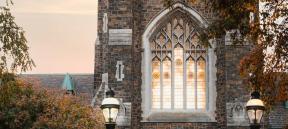 The window in alumni memorial with golden light shining through