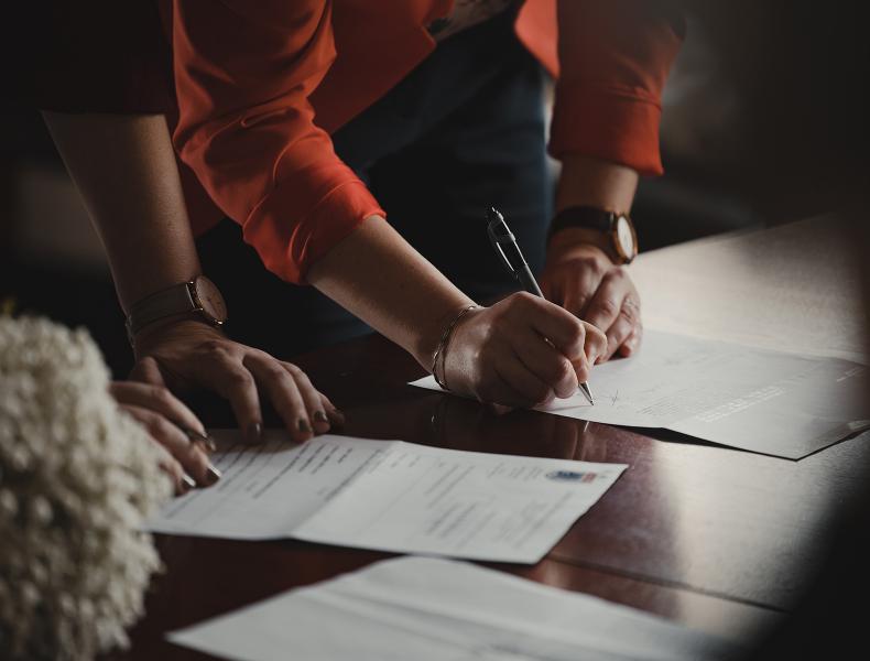 Two people working on insurance documents