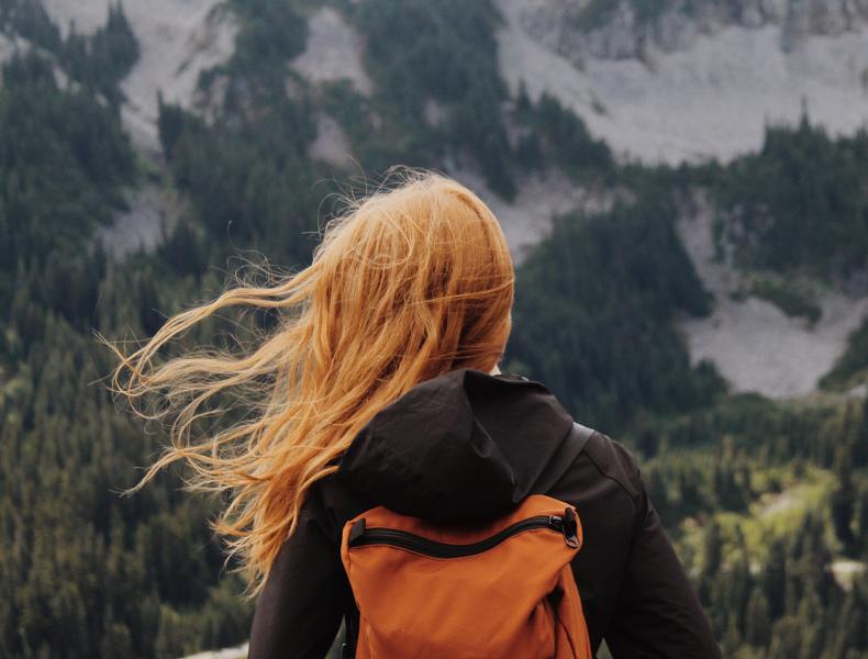 Woman with backpacking looking at mountains 