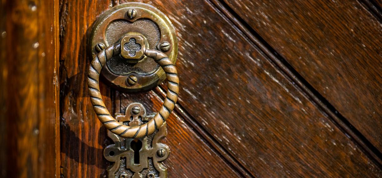 Close up image of brown wood door